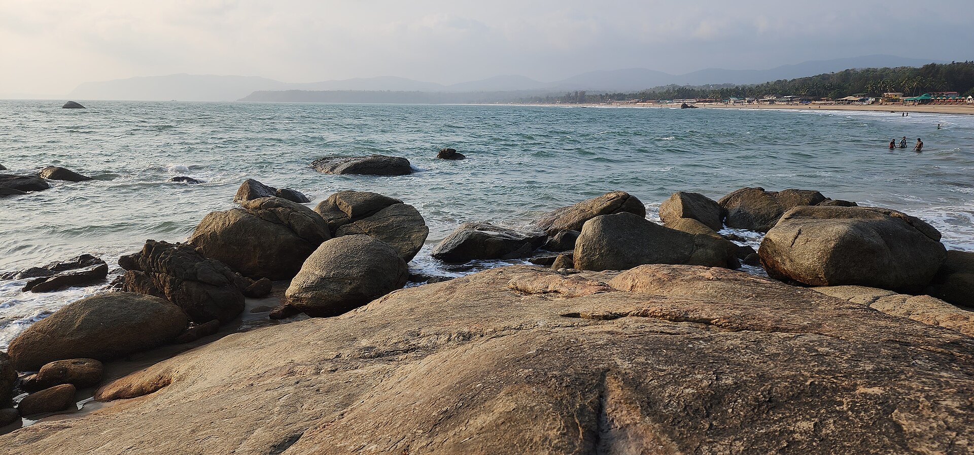 Pristine wide golden sand shoreline and evening sunset light at Agonda Beach in South Goa
