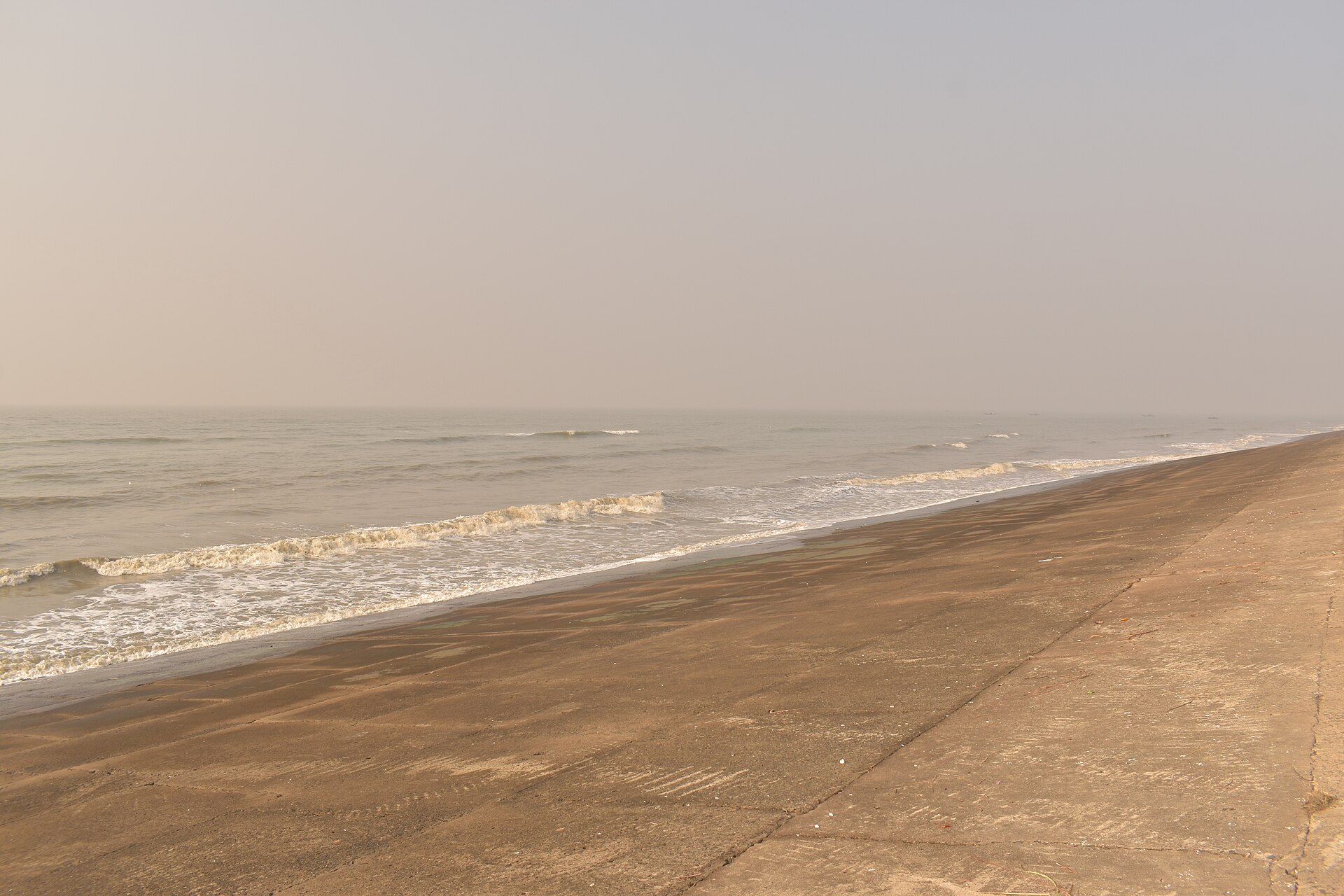 Vast hard-packed sandy beach meeting the gentle waves of the Bay of Bengal at Bakkhali in South 24 Parganas