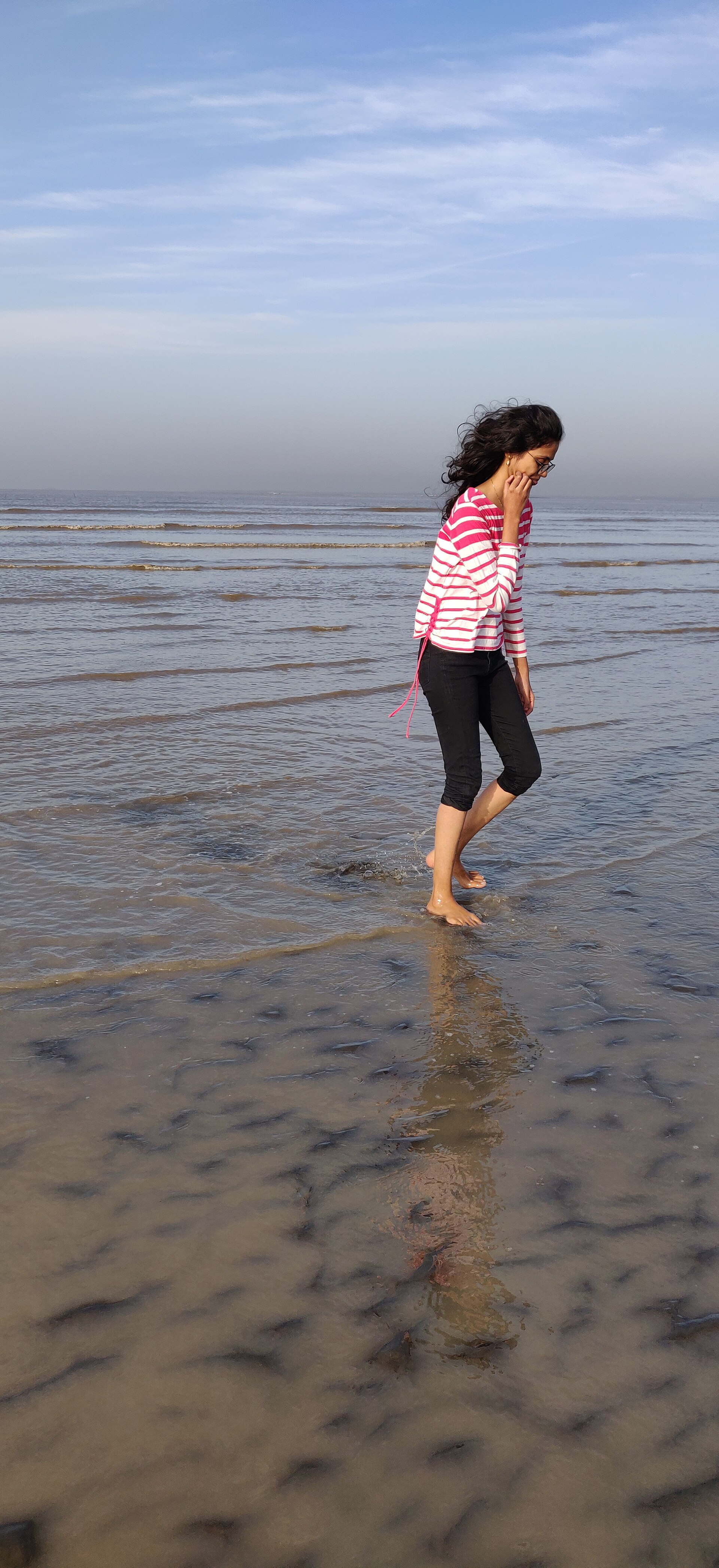 Expansive dark sandy shoreline and Arabian Sea waters at Dumas Beach near Surat, Gujarat