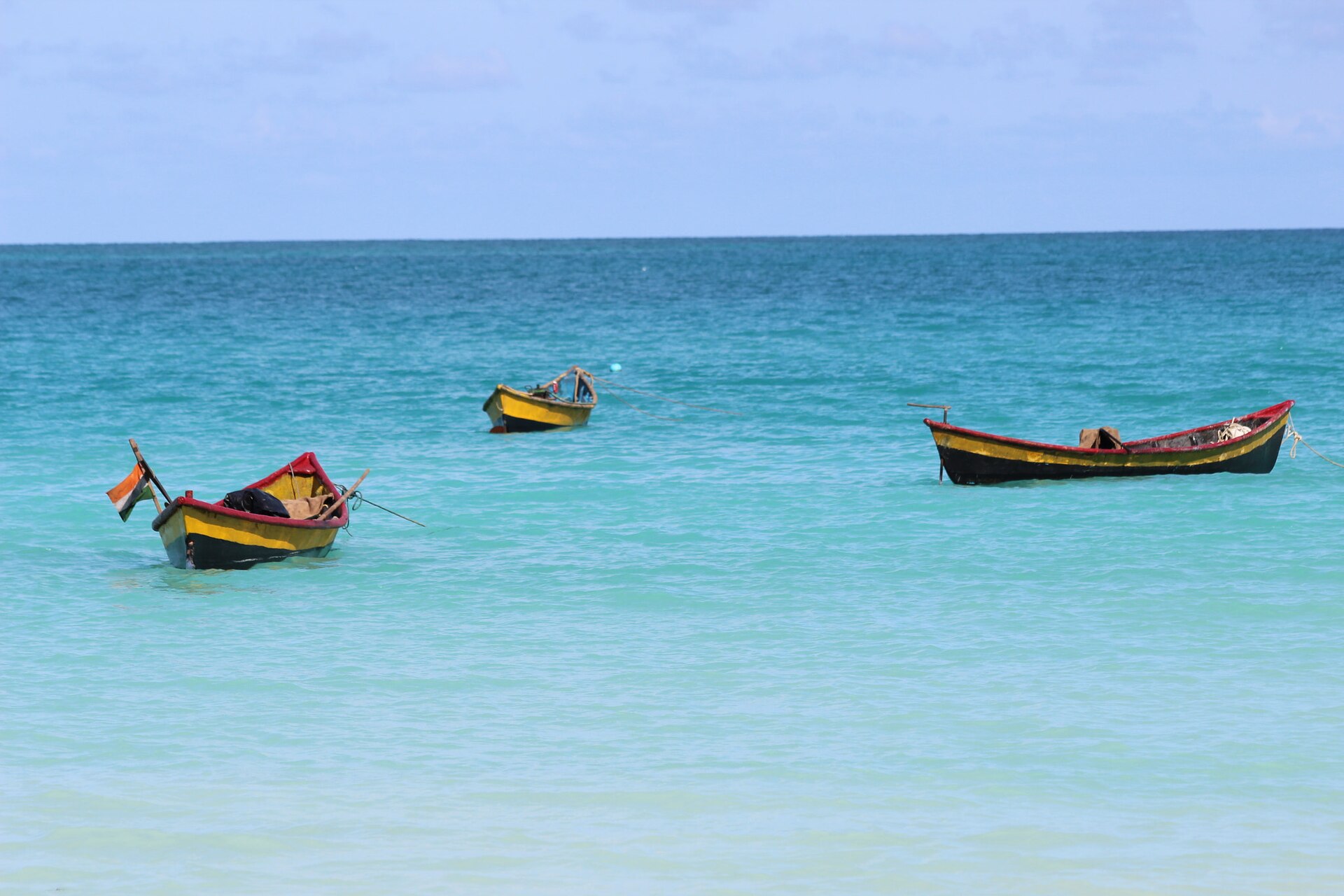 Luminous turquoise Andaman Sea waters, white sands, and black volcanic rocks at Kalapathar Beach on Havelock Island