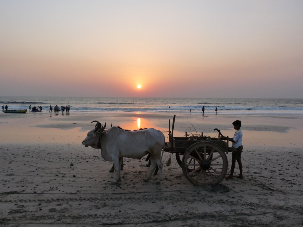 White sand shoreline and sunset reflections over Arabian Sea surf at Kashid Beach in Raigad, Maharashtra