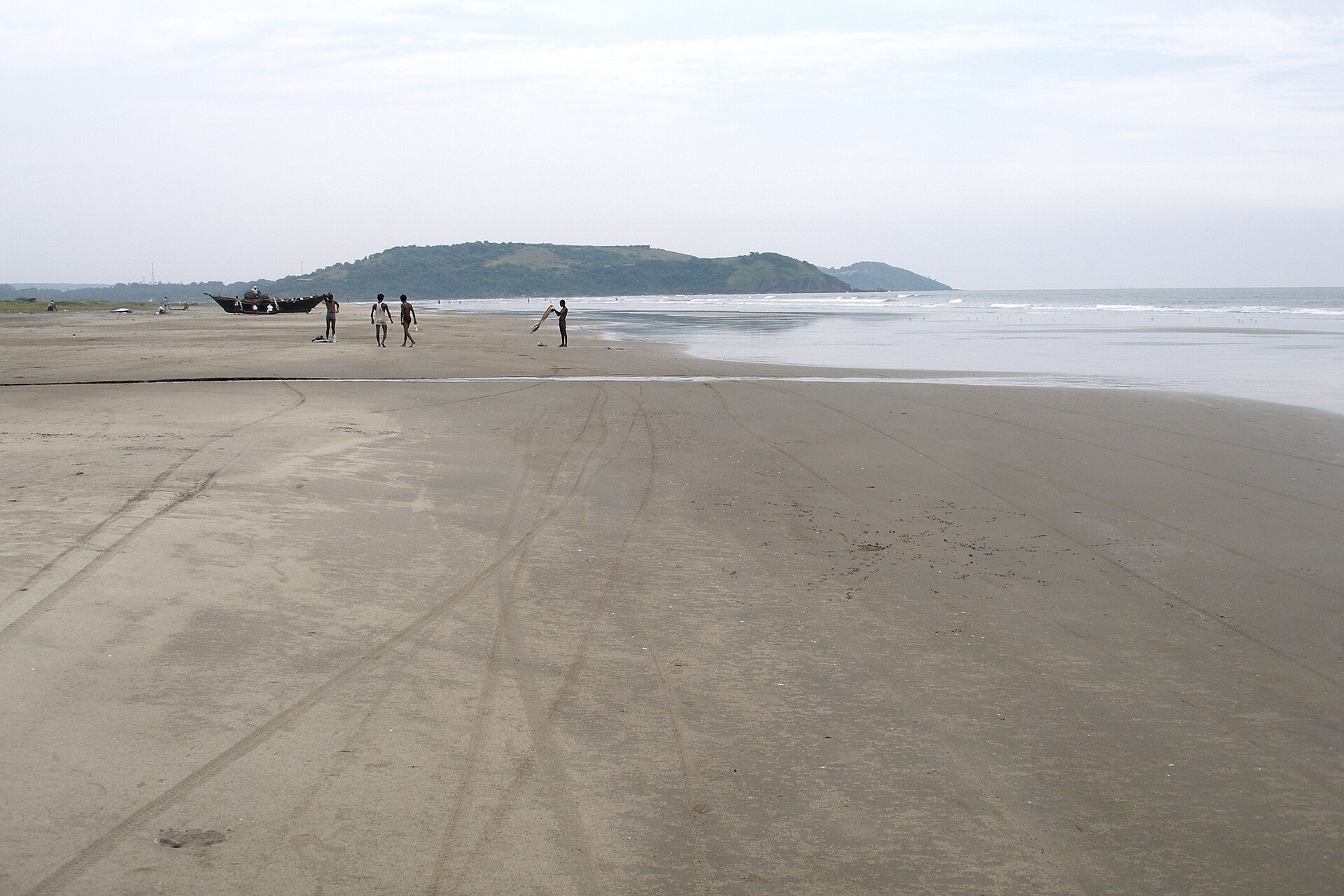 Vast open golden sands and gentle Arabian Sea waves at Morjim Beach in North Goa