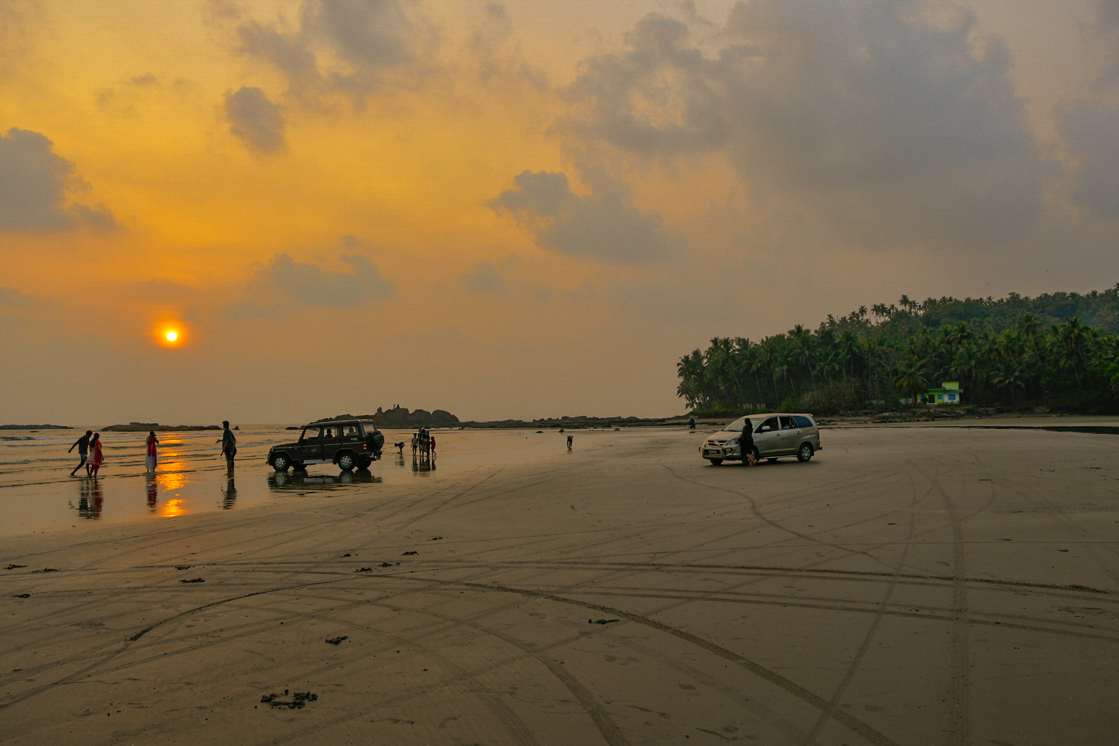 Panoramic view of the 4 kilometer firm sandy shoreline and breaking Arabian Sea waves at Muzhappilangad Drive-in Beach in Kannur, Kerala