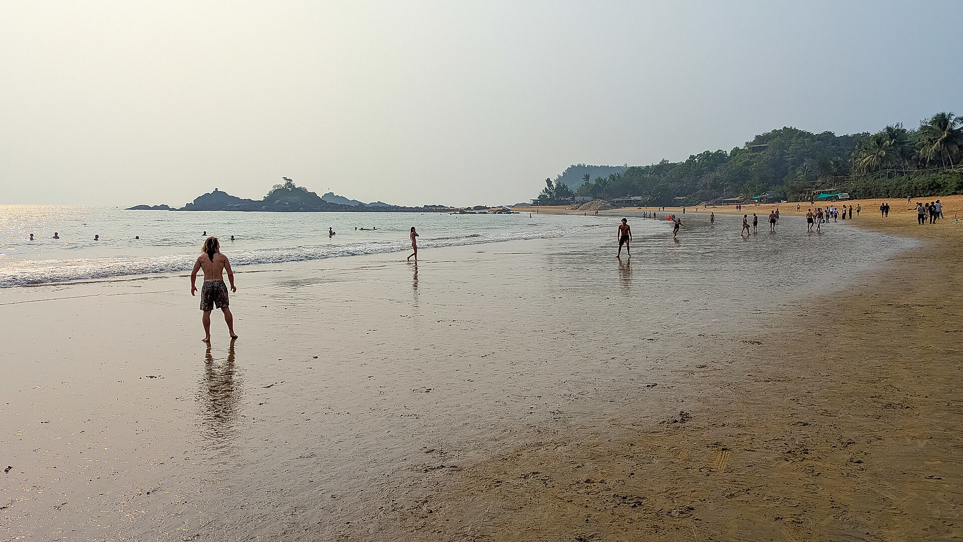 Rocky basalt formations and dual sandy crescents at Om Beach in Gokarna, Karnataka overlooking the Arabian Sea