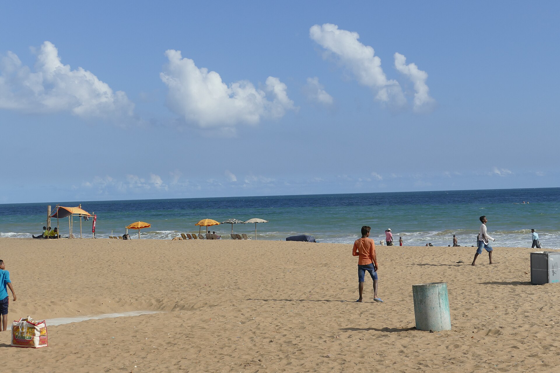 Expansive golden sands and powerful breaking waves of the Bay of Bengal at Puri Beach in Odisha