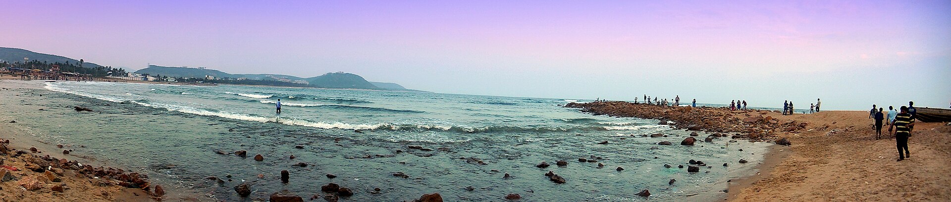 Panoramic view of the golden sand crescent bay and Eastern Ghats hills at Rushikonda Beach in Visakhapatnam, Andhra Pradesh