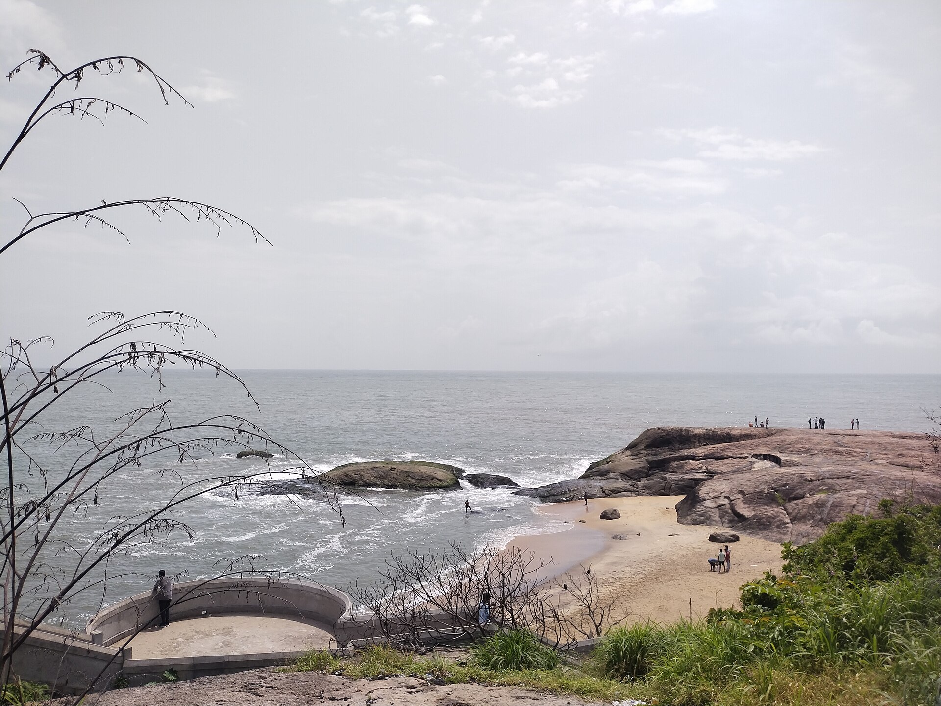 Colossal black basalt Rudra Shile rock boulders rising from the crashing Arabian Sea waves at Someshwara Beach in Mangalore