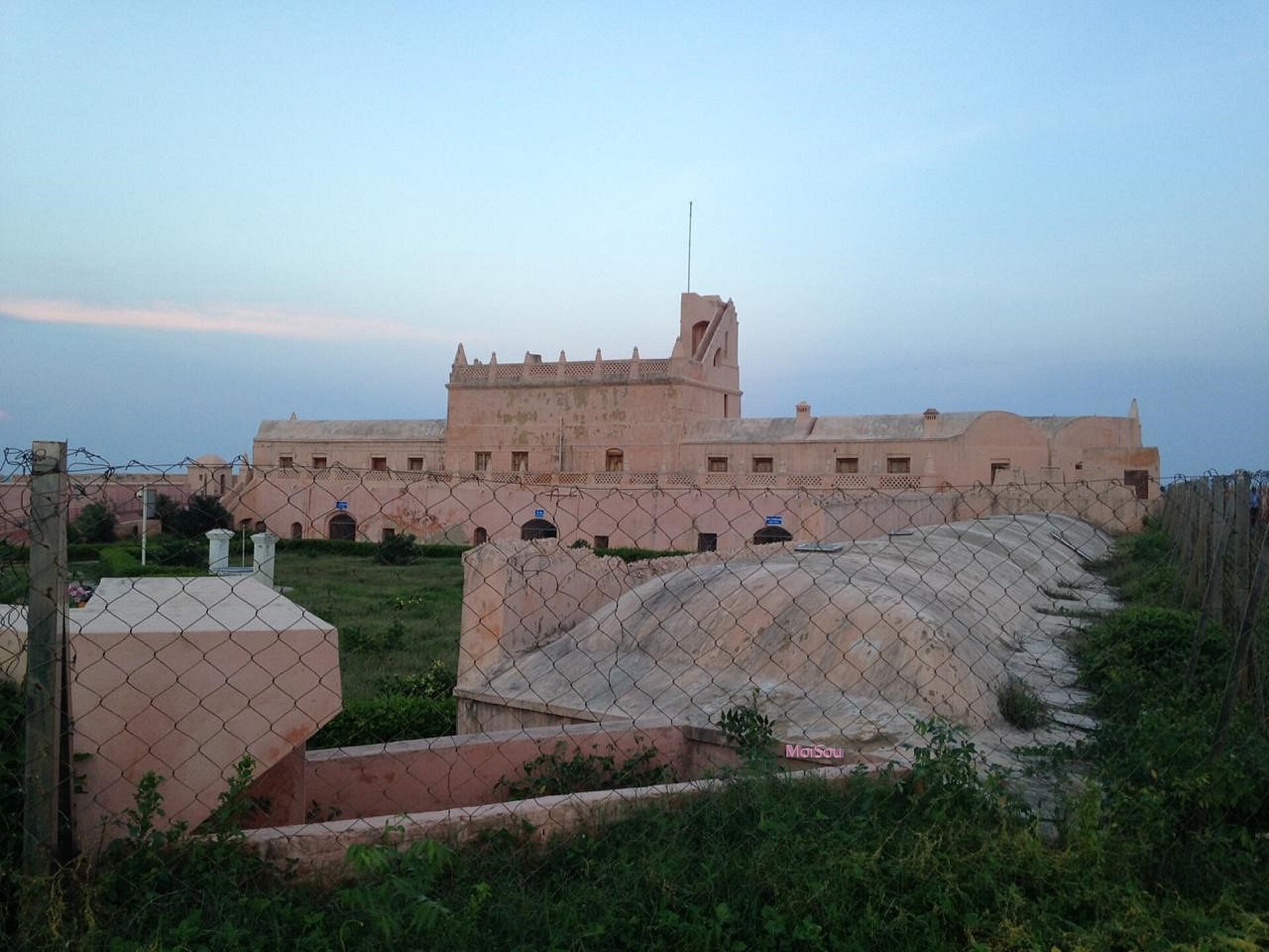 Imposing mustard-yellow walls and bastions of 1620 Danish Fort Dansborg directly overlooking Tranquebar Beach